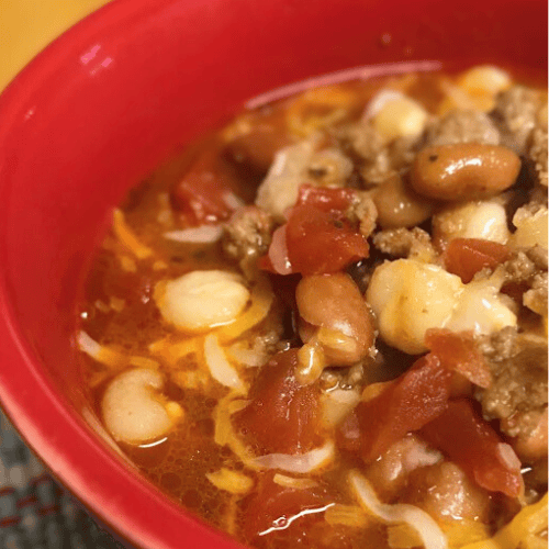 Bowl of hominy chili with ground beef.