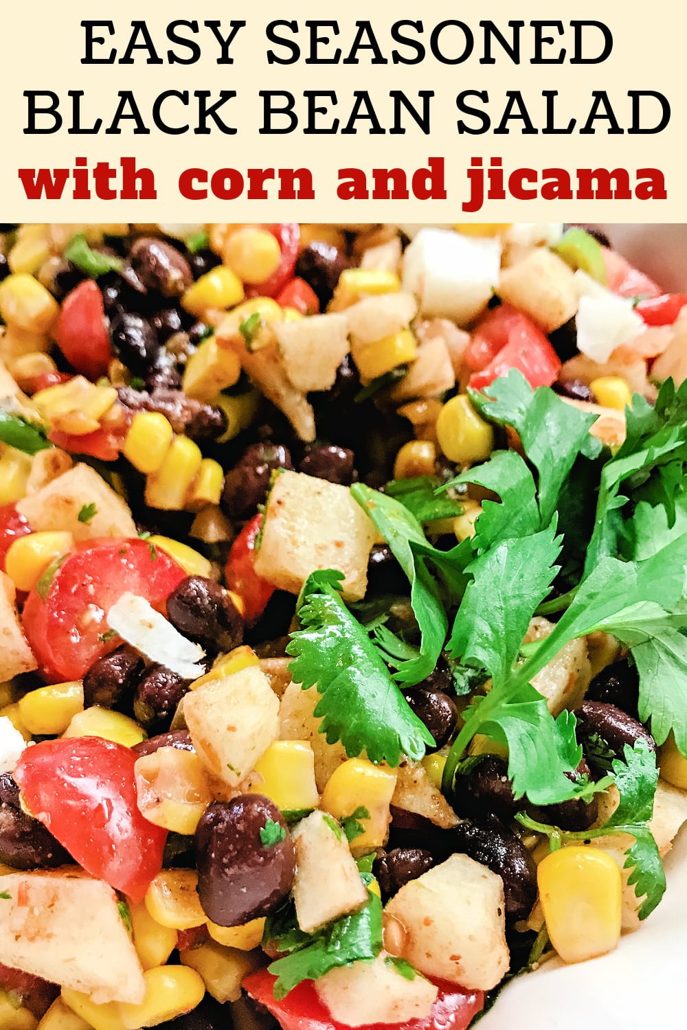 Seasoned Black Bean Salad with jicama, corn, and tomatoes, garnished with cilantro.  