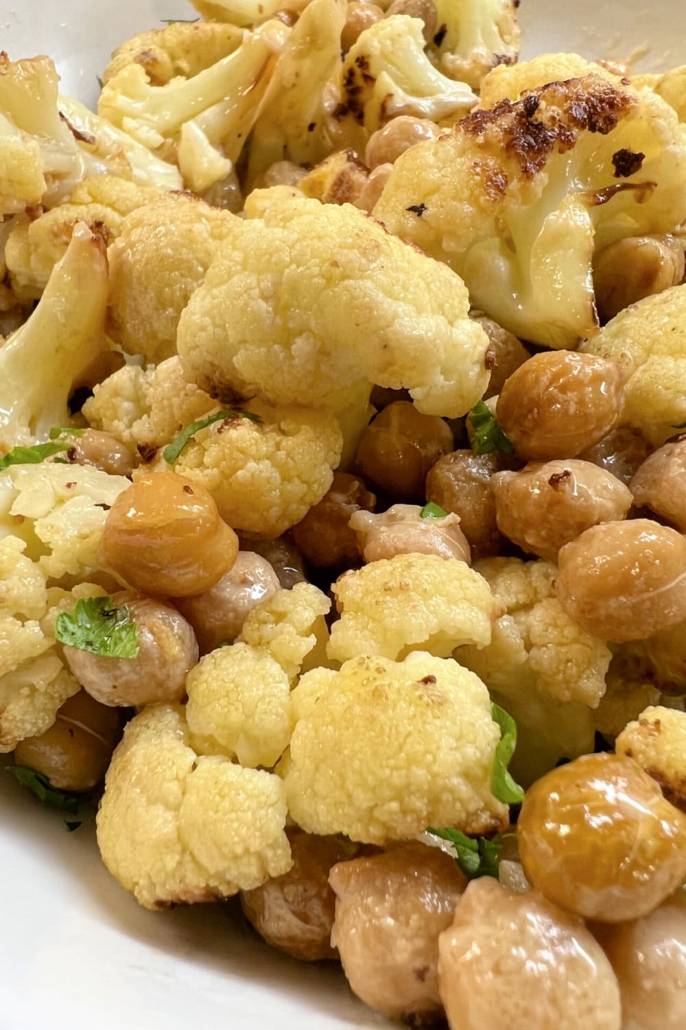 Golden brown chickpeas with cauliflower on a sheet pan. 