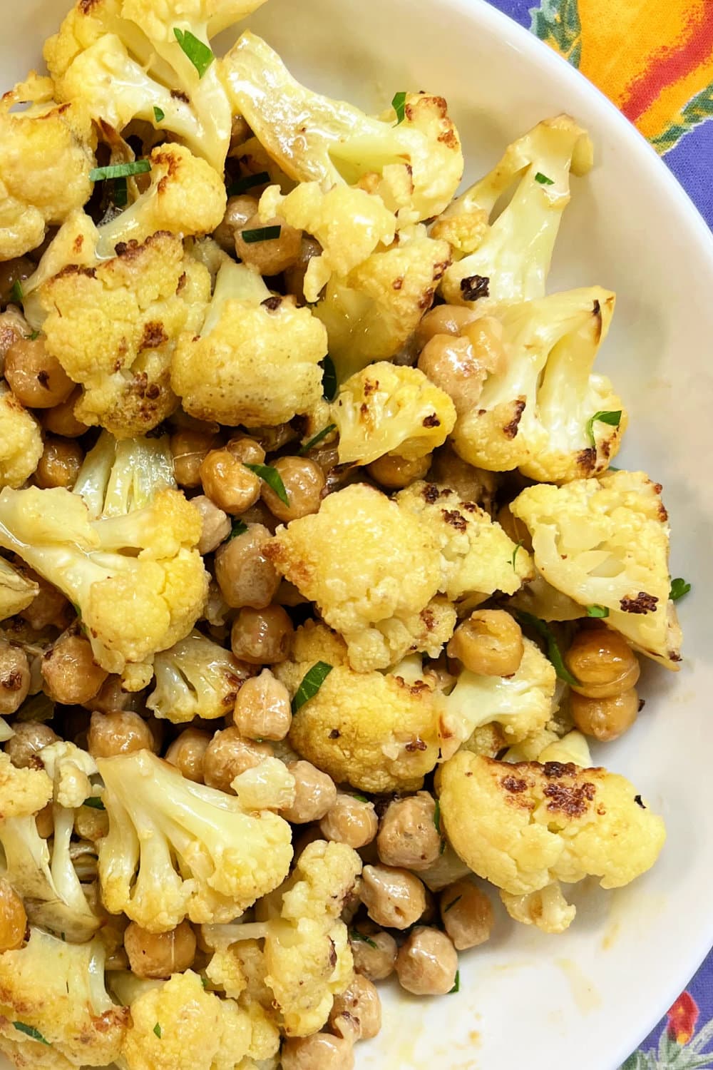 A plate full of roasted cauliflower and chickpeas. 