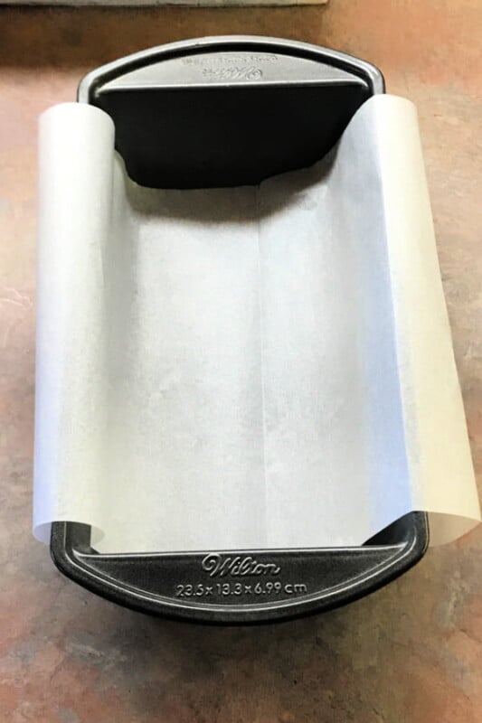 A sheet of parchment laid into a bread pan.