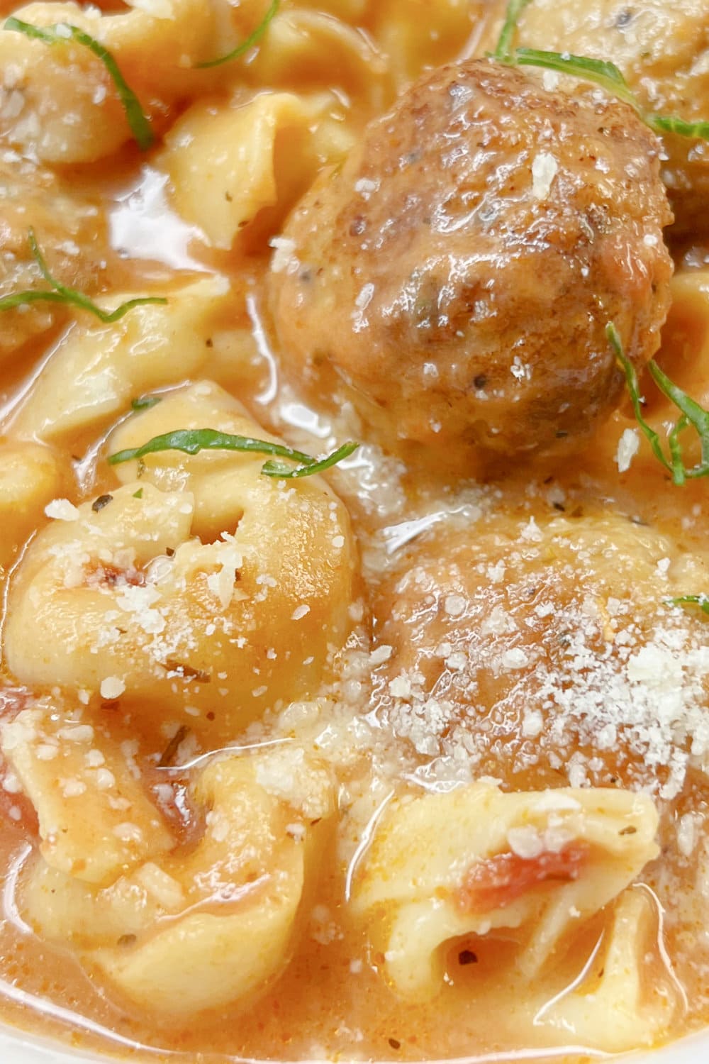 Cheese tortellini in a meatball soup that's hot and ready to enjoy. 