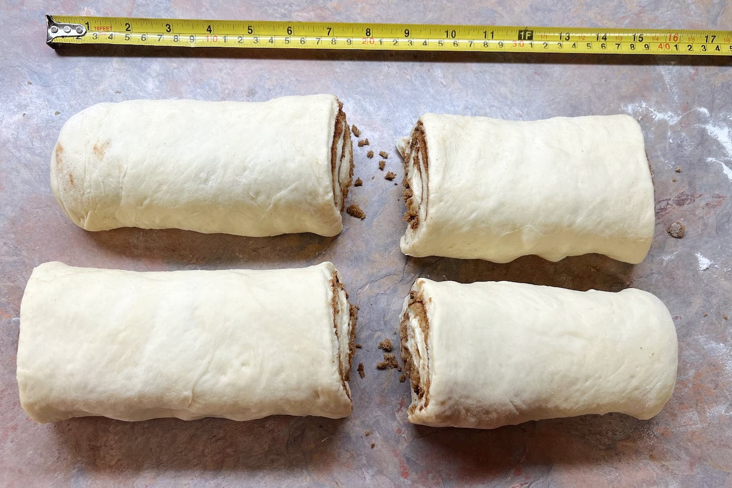 The halves of cinnaon roll dough cut into quarters. 