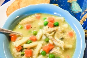 A bowl filled with chicken and noodle soup.