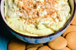 A bowl of coconut cream pie dip with vanilla wafers.