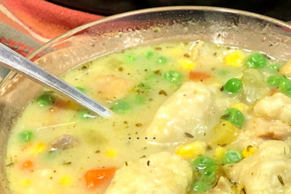 Up close shot of a bowl of chicken and dumplings.