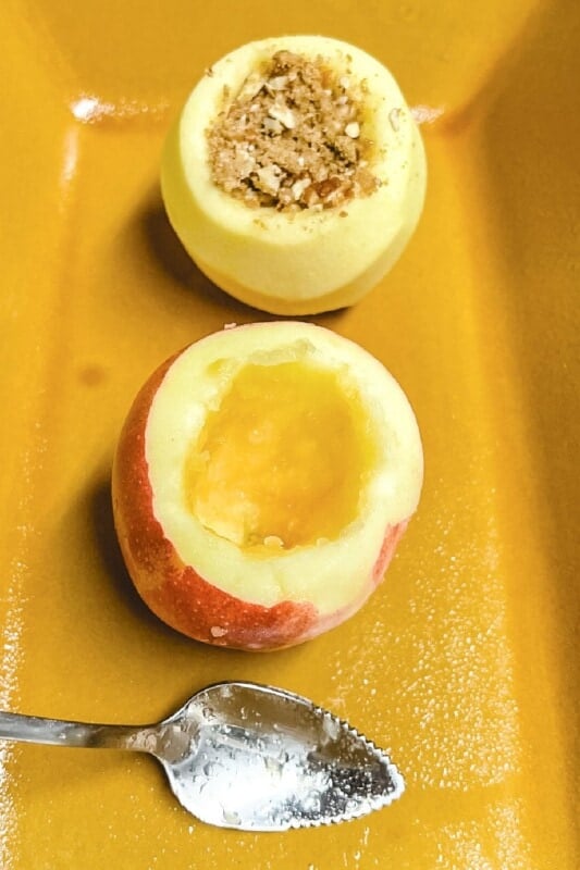 Cored apples in a baking dish.