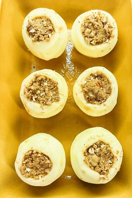 Stuffed apples for a fall dessert in a baking dish. 