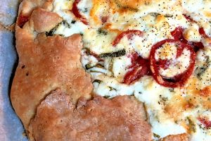 You have not lived until you've experienced Rustic Tomato Pie, and I'm not even kidding! One of our all-time favorite summer treats when homegrown tomatoes are in abundance, this tomato pie is like eating a heavenly cheese and tomato pizza; the combination of sweet tomatoes with the fresh basil and the goat cheese topping is completely mouth-watering. #TomatoPie #HomegrownTomatoes #Basil #GoatCheese