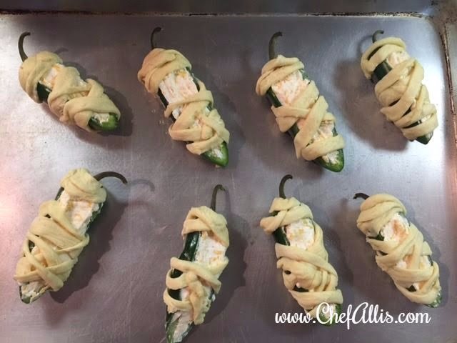 These Mummy Poppers are easy Halloween snacks that are so fun to create when Halloween parties roll around.  Mummy Poppers are fun and cute Halloween food!