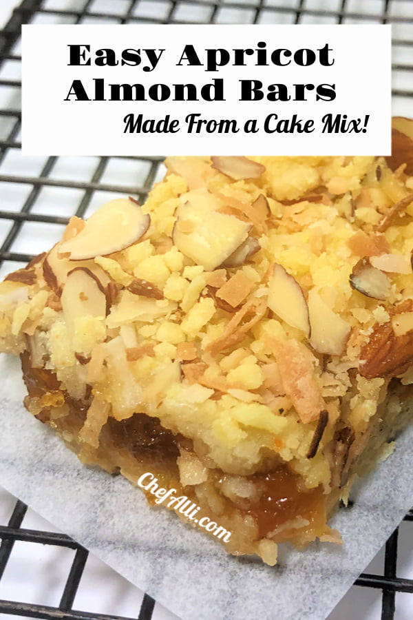 One apricot almond bar sitting on a piece of parchment paper, on top of a cooling rack.