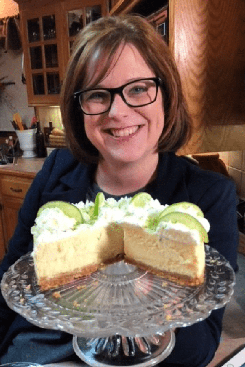 Delicious Key Lime Cheesecake on a pedestal cake plate. 