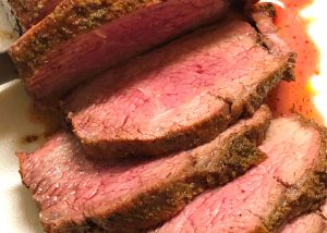 Hard to resist medium-rare sliced of beef tri tip roast.