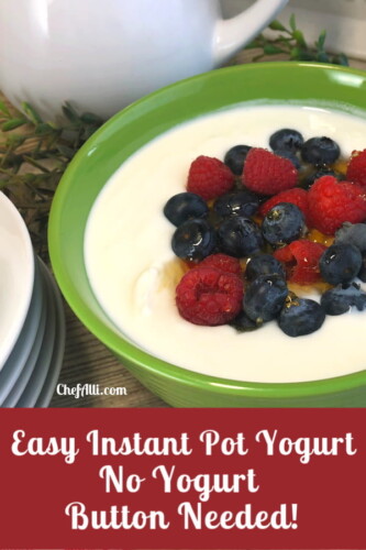green bowl of yogurt topped with berries and honey.
