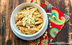 A bowl full of creamy Tex Mex pasta topped with crushed tortilla chips.