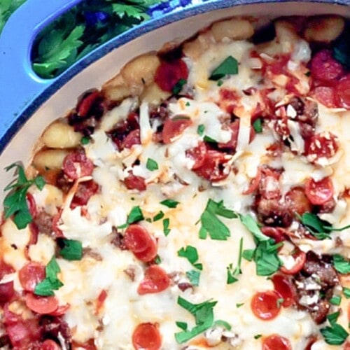 A blue skillet full of meat lovers gnocchi bake.