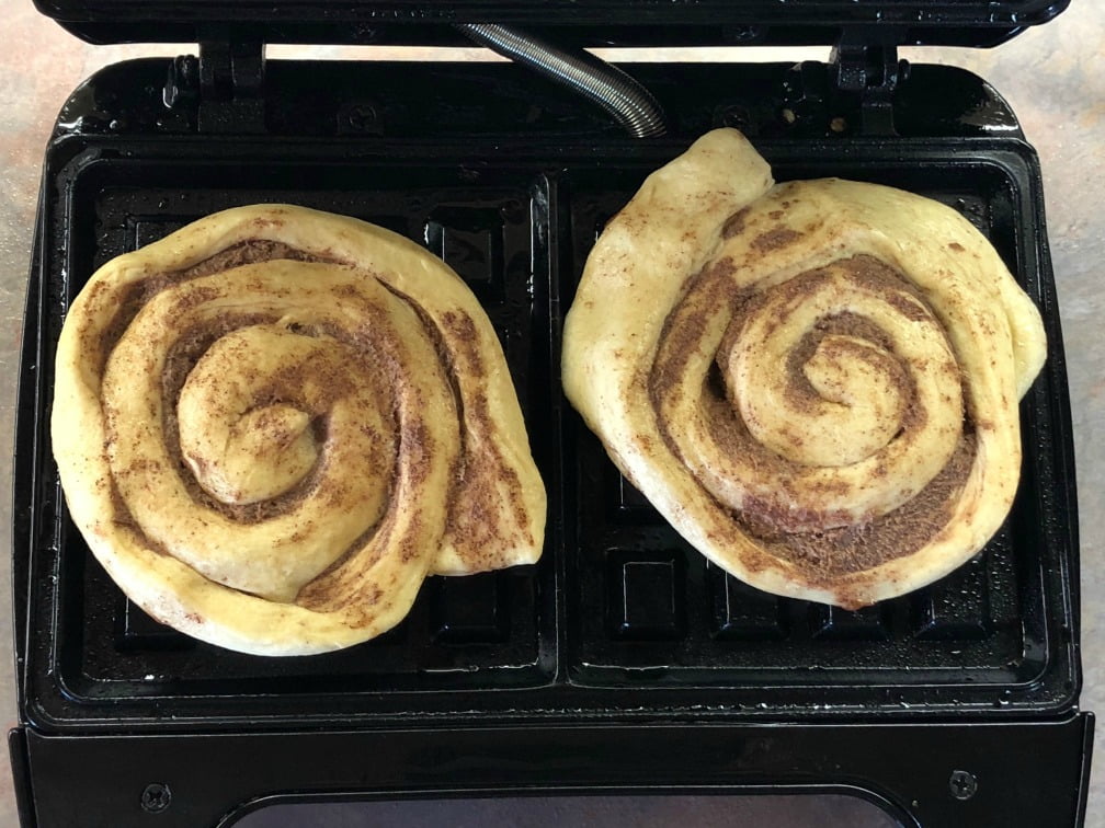 Whether you're celebrating National Waffle Day or just need something fun and decadent for a special breakfast treat, these Cinnamon Roll Waffles are your ticket! And, you don't need a super fancy waffle iron, either - I think mine came from a garage sale and it's super basic, but it works great since I don't make waffles that often. I love how easy this recipe is to throw together! Simply pop open a can of refrigerated cinnamon rolls, cut into quarters and "smush" them a bit before cooking in your waffle maker.  Lastly, top them with all kinds of wonderful, and you have the makings of a national treasure.