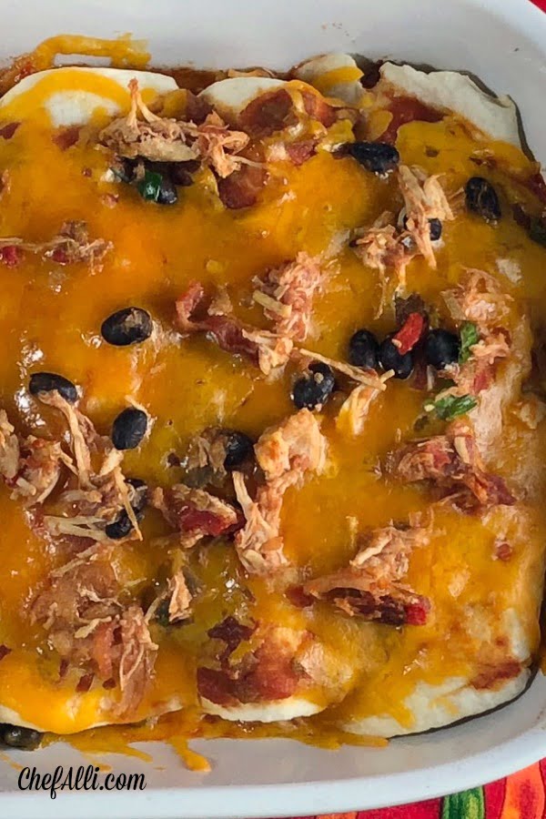 These Chicken and Bacon Black Bean Enchiladas make a fun weeknight meal and I love to double this recipe to make TWO pans - one for dinner now and one for dinner later....then I pull that sucker right out of the freezer. And, this casserole makes a pretty neat gift when somebody's grieving a loss or celebrating a birth - who doesn't love a pan of enchiladas delivered to their door when in need??   #chicken #bacon #enchiladas #casserole