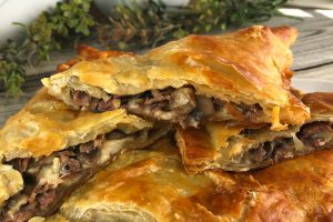Puff Pastry Roast Beef Packets stacked on a platter.