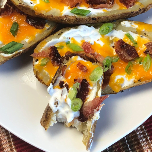 If you're looking for the perfect party appetizer, guess what??  You've just located it! Everybody seems to love these little boats of heavenly goodness - crispy skins, cheddar cheese, bacon, scallions and sour cream. 