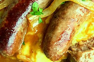 My family really enjoys this traditional St. Patrick's Day dish of cooked sausages (bangers) and mashed potatoes (mash) served with onion gravy and made in minutes right in our Instant Pot.  #bangersandmash #instantpot #StPatricksDay 