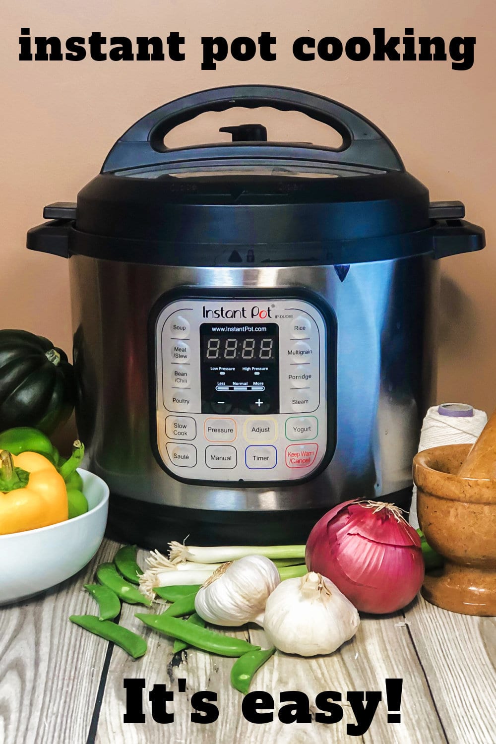 An Instant Pot with vegetables surrounding it. 