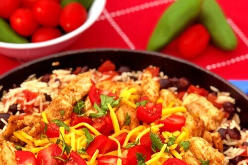 Ready for a fiesta in your mouth? This Chunky Chicken Burrito Skillet Meal brings it! Tender chunks of spiced chicken combined with saucy rice and black beans make up this quick skillet meal. Just add your favorite cheese and toppings to customize. #SkilletMeal #SpeedyMeal #Mexican #burrito #chicken