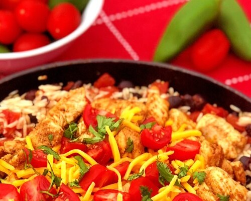 Ready for a fiesta in your mouth? This Chunky Chicken Burrito Skillet Meal brings it! Tender chunks of spiced chicken combined with saucy rice and black beans make up this quick skillet meal. Just add your favorite cheese and toppings to customize. #SkilletMeal #SpeedyMeal #Mexican #burrito #chicken