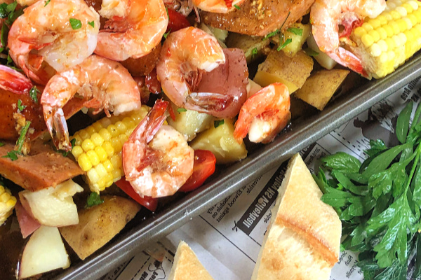 Here's the answer to the perfect summer party: Low Country Sheet-Pan Shrimp Boil! Talk about fun and easy and your guests will squeal with delight. And, as the host, you're going to love it because there's hardly any clean up required. #LowCountry #ShrimpBoil #Shrimp #Cajun #Easy #Andouille #SheetPanMeal #SheetPanDinner