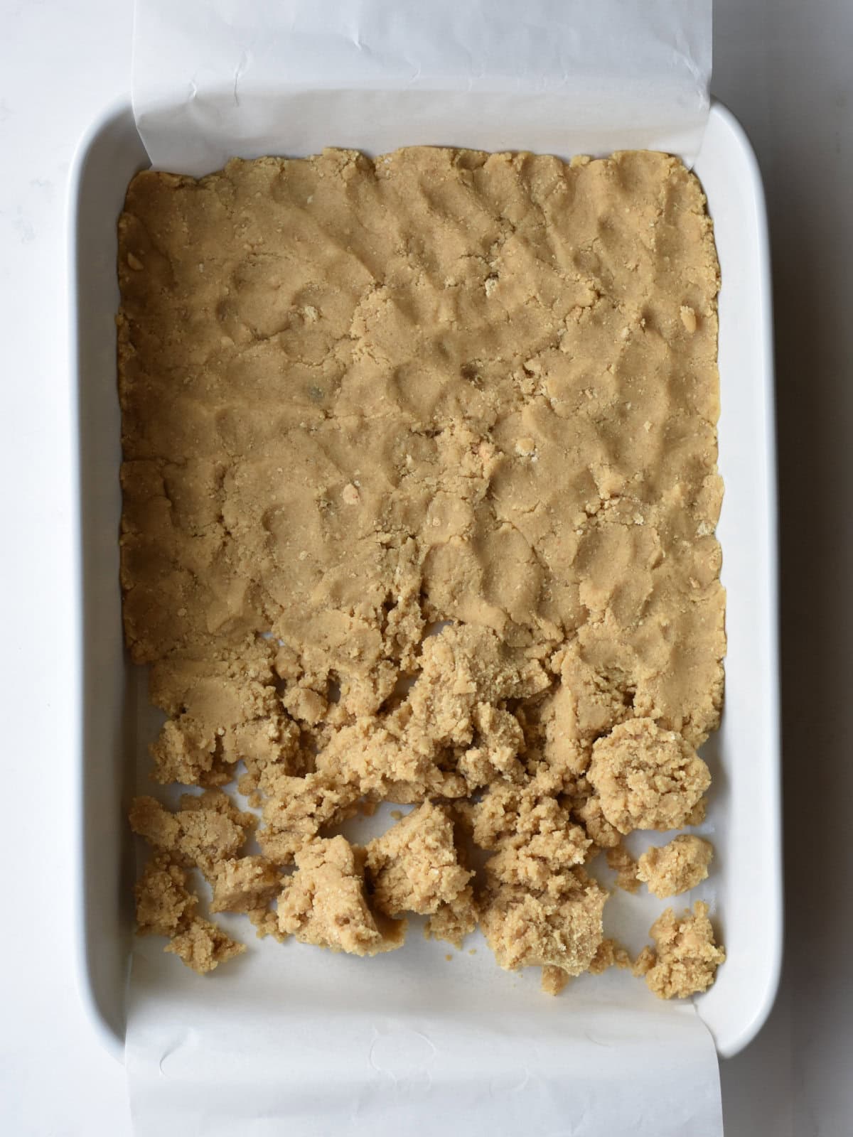 Cookie batter in the bottom of a 9X13 pan. 