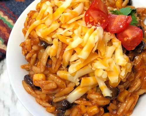 Everybody loves an easy orzo 30-minute meal that features the familiar, festive flavors of Mexican enchiladas, right? We often enjoy a speedy skillet meal like this one that involves just one-pan and only two-steps.  #speedymeal #oneskillet #pasta #onepanmeal #enchiladas #orzo