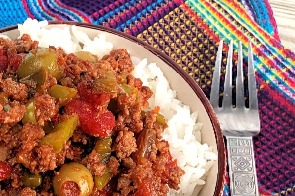 Picadillo Over Rice is a traditional Cuban dish made with ground beef that's typically eaten over white rice. A Latin comfort-food, this home-style skillet meal is simple and quick to make, with some referring to it as "hash". I personally refer to it as CRACK....I cannot stop eating it, and I can't wait for you to try it.  #Picadillo #Cuban #FamilyStyle #SkilletMeal #GroundBeef #Hash #LatinFood