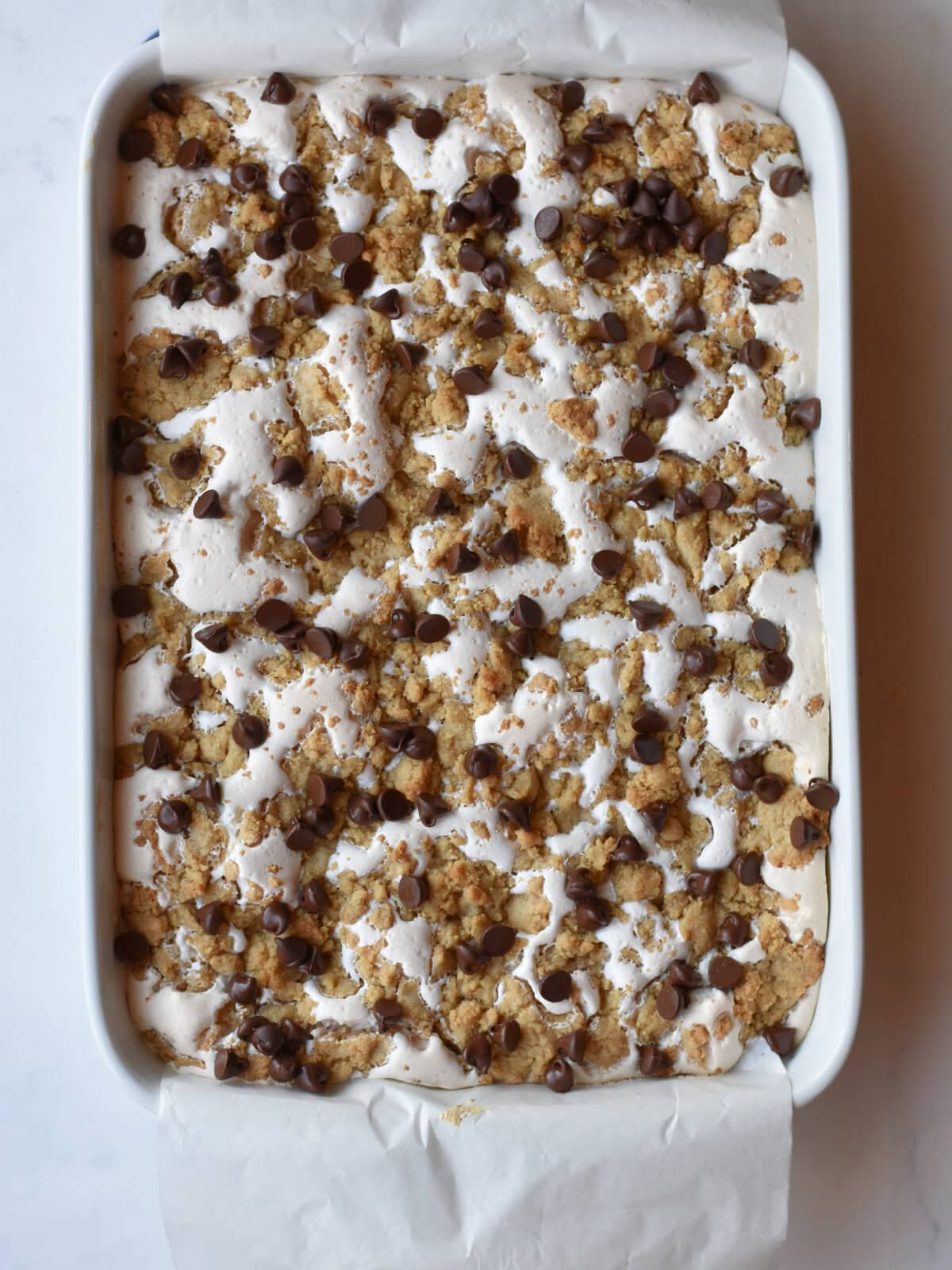 Cooked layered dessert with cookie dough, chocolate, marshmallow fluff and chocolate chips. 