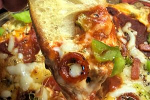 Looking for an easy baked appetizer for your next gathering? Your friends and family will flip over this Hot and Creamy Pizza Dip that's made with cream cheese, pepperoni, and sausage and ready in a flash.  Serve with toasted baguette slices or your favorite pita chips and crackers. #pizza #dip #easy #baked #appetizer #cheesy #FootballFriday #watchparty #SuperBowl
