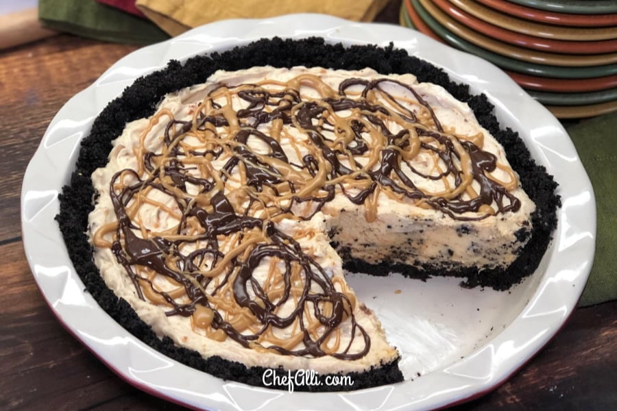 A whole No-Bake Butterfinger Pie with one slice cut and removed.