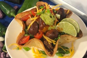 Flour tortilla basket filled with beef and beans.