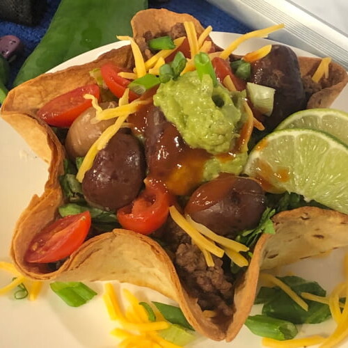 Flour tortilla basket filled with beef and beans.