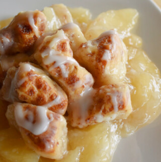 A warm serving of Cinnamon Roll Apple Bake on a white plate.