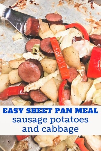 Sausage coins with potatoes and cabbage baked on a sheet pan. 