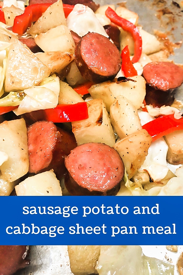 A loaded sheet pan full of kielbasa sausage, potatoes, and tender cabbage. 