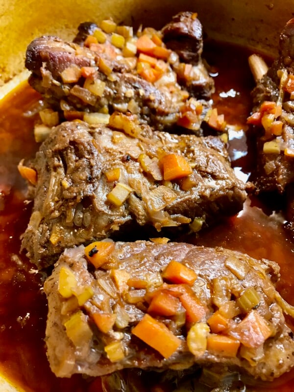simmering-beef-short-ribs Simmering beef short ribs that are finished cooking.