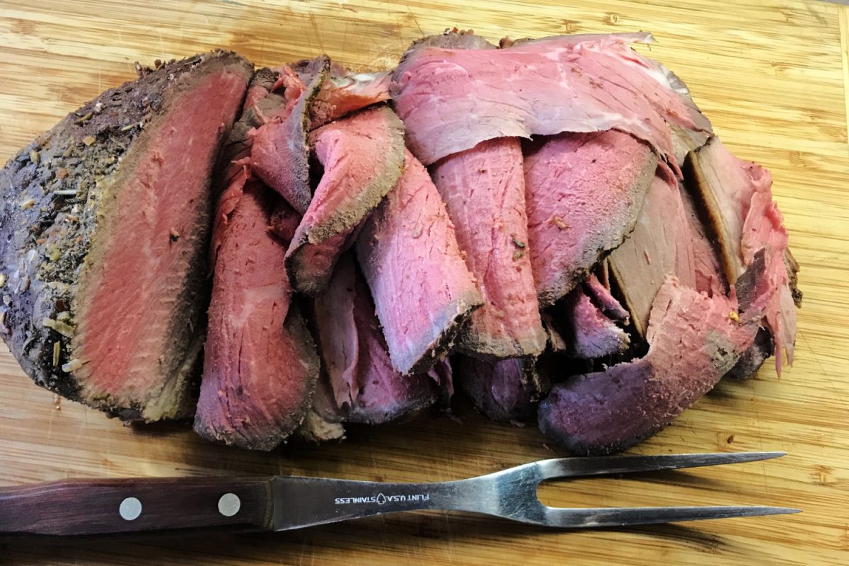 Thinly sliced eye of round roast on a cutting board. 