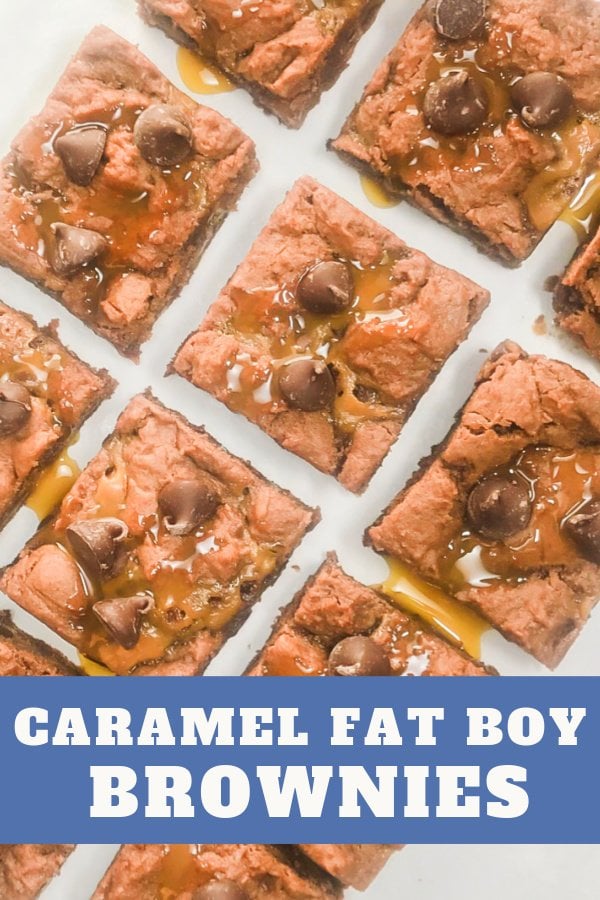 Square brownies with caramel topping on a sheet of parchment paper.