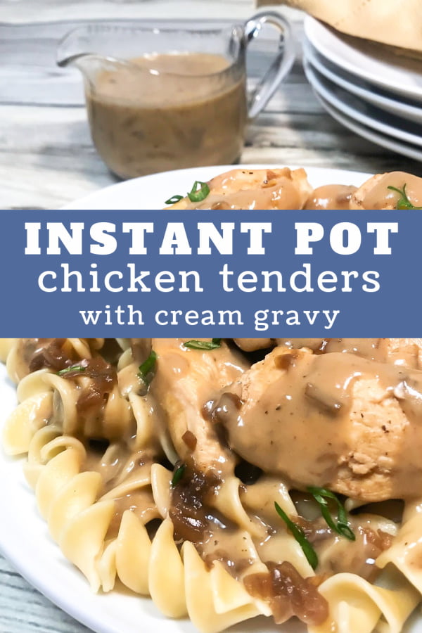 Chicken tenders topped with gravy nestled in a bed of pasta on a white plate. 