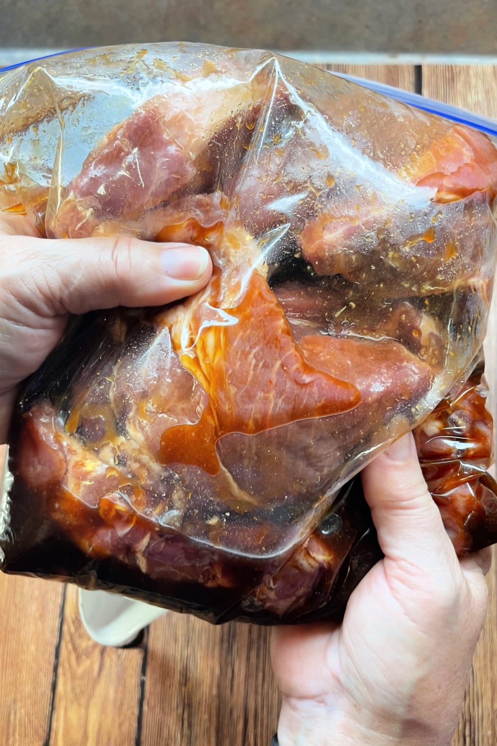 Massaging the marinade into the ribs in a gallon bag. 