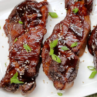 Saucy and tender, Asian BBQ Ribs on a white plate.