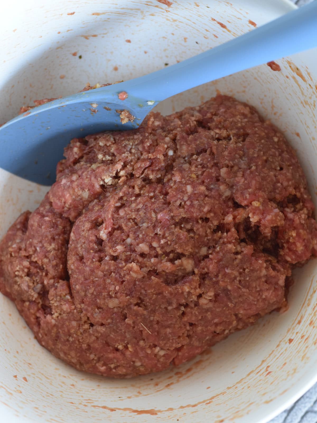 Meatloaf-Pie-Ground-Beef Lean ground beef with panko breadcrumbs and seasoning, mixed in a white bowl.