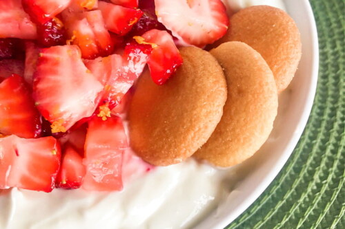 Vanilla wafer cookies perched on top of Strawberry Shortcake Dip.