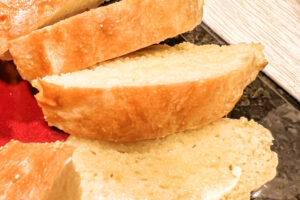 Buttered slices of Peasant Bread stacked on a platter.