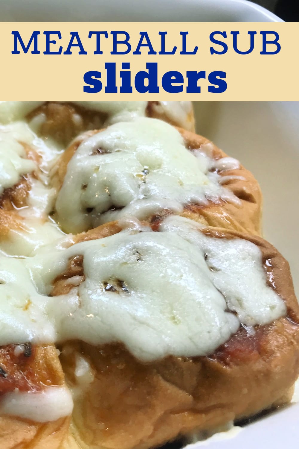 Baked Meatball Sub Sliders topped with melted mozzarella cheese. 